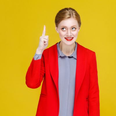 Ginger red head business woman in red suit have good plan, idea.